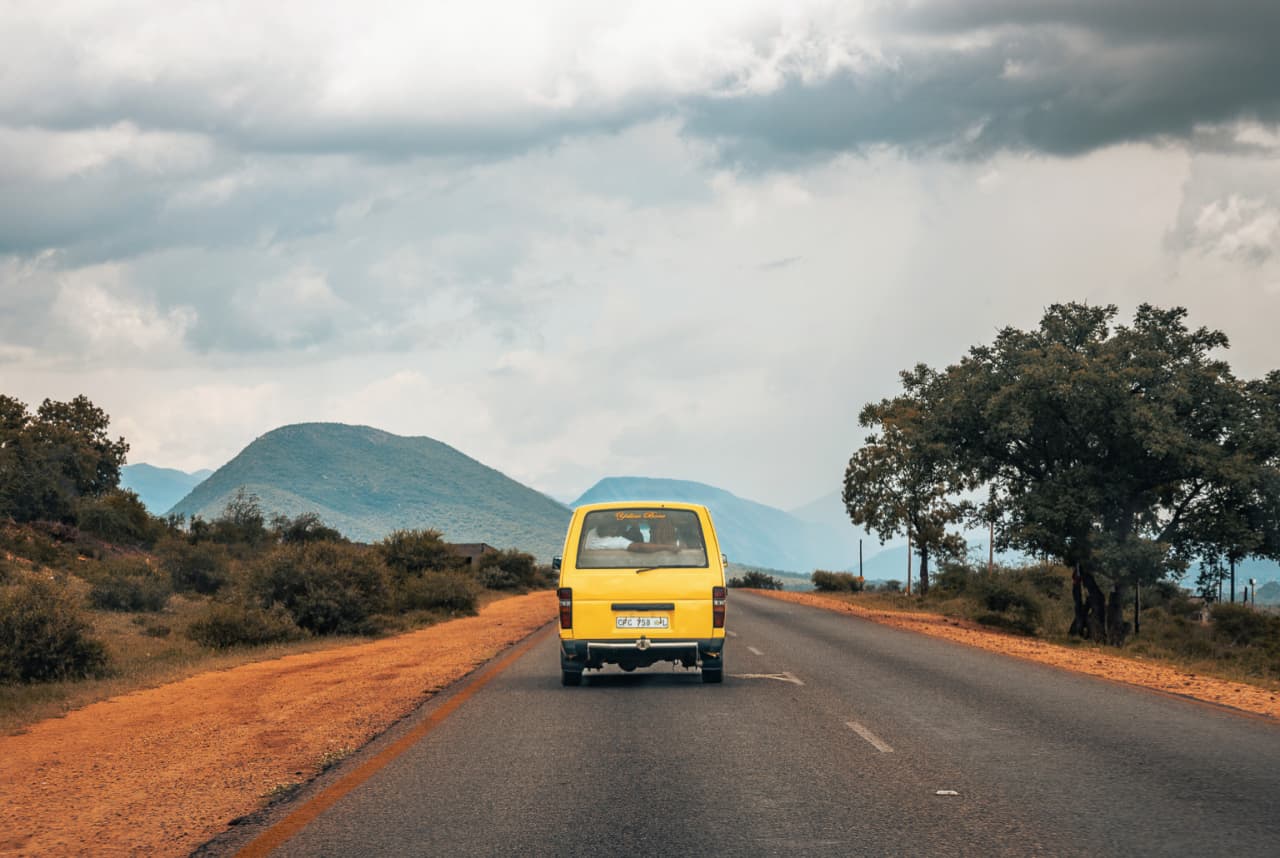 Yellow Bone — a yellow minibus travelling through the Limpopo landscape